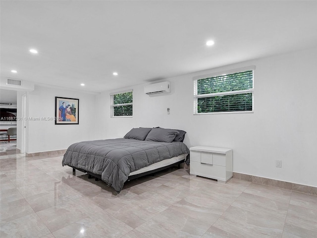 bedroom with an AC wall unit