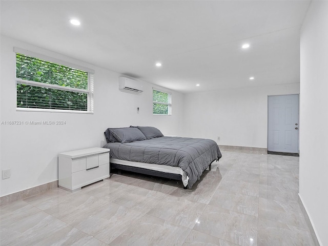 bedroom with a wall mounted AC and multiple windows