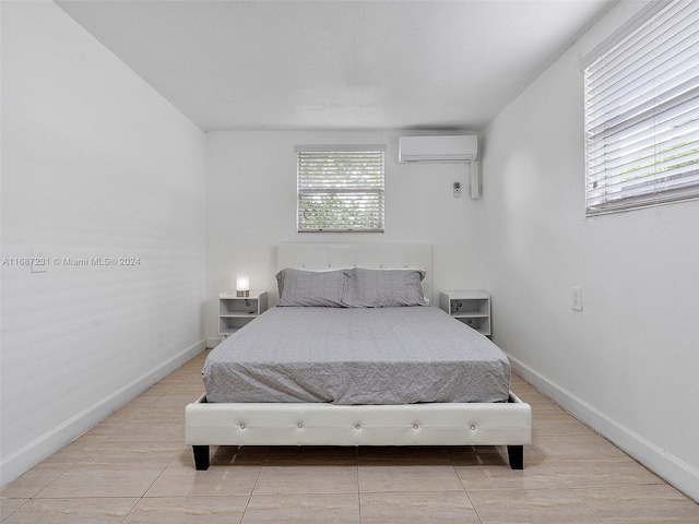 tiled bedroom featuring a wall mounted air conditioner