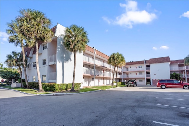 8000 Lagos De Campo Blvd Unit A-106, Tamarac, FL 33321 - view of apartment building / complex featuring uncovered parking