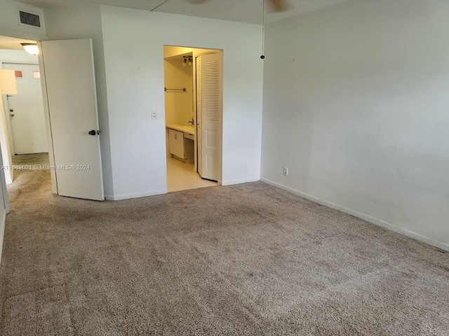 unfurnished bedroom with light colored carpet