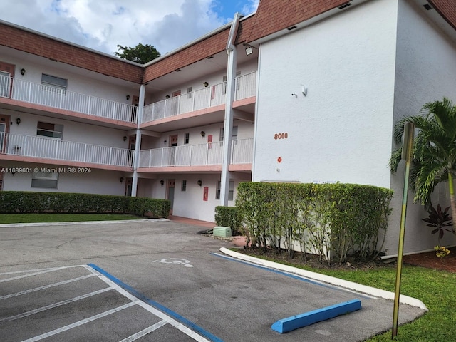 8000 Lagos De Campo Blvd Unit A-106, Tamarac, FL 33321 - view of building exterior with uncovered parking