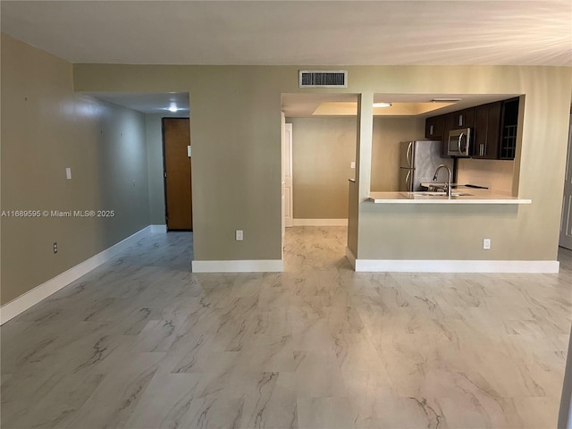 unfurnished living room with sink