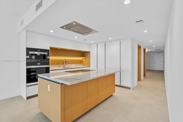 1135 103rd St Unit 403, Bay Harbor Islands, FL 33154 - kitchen featuring modern cabinets, stainless steel double oven, black electric cooktop, a kitchen island, and white cabinets