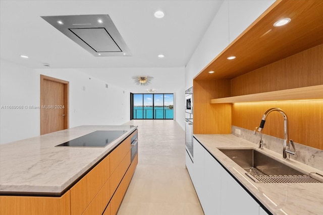1135 103rd St Unit 403, Bay Harbor Islands, FL 33154 - kitchen with black electric cooktop, open shelves, modern cabinets, recessed lighting, and light stone counters
