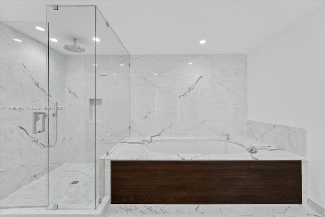 bathroom with shower with separate bathtub