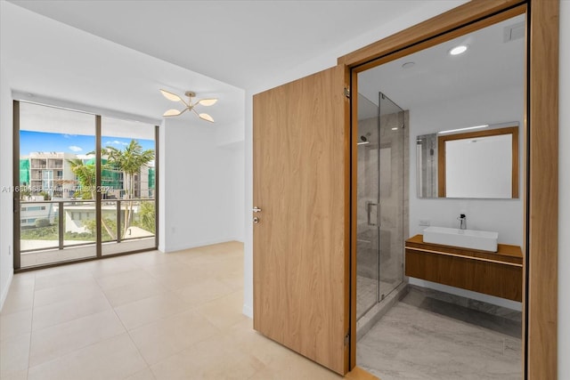 1135 103rd St Unit 403, Bay Harbor Islands, FL 33154 - full bathroom with a wall of windows, a stall shower, and vanity