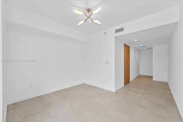 empty room with an inviting chandelier