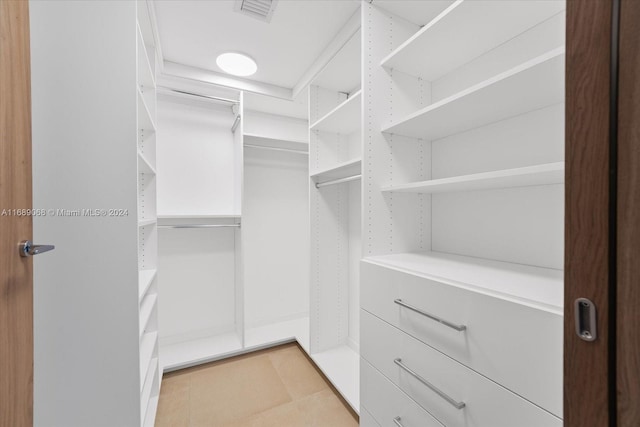 1135 103rd St Unit 403, Bay Harbor Islands, FL 33154 - walk in closet featuring light tile patterned flooring