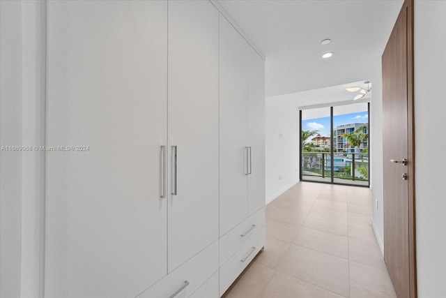 1135 103rd St Unit 403, Bay Harbor Islands, FL 33154 - hallway featuring a wall of windows and light tile patterned floors
