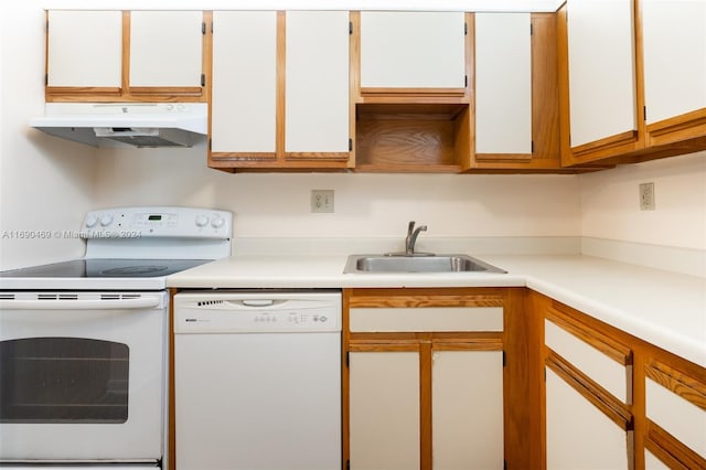 kitchen with white cabinets, sink, and white appliances