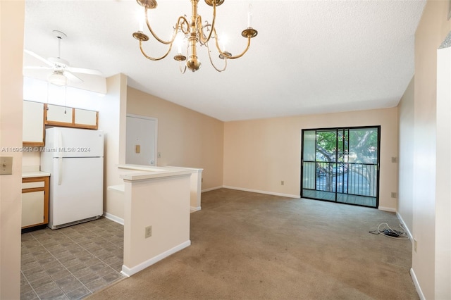 kitchen featuring white fridge, decorative light fixtures, vaulted ceiling, light colored carpet, and ceiling fan with notable chandelier