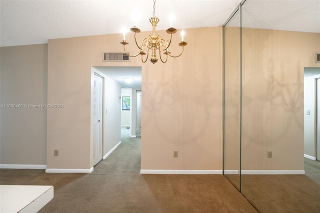 unfurnished dining area with lofted ceiling, a textured ceiling, carpet floors, and a notable chandelier