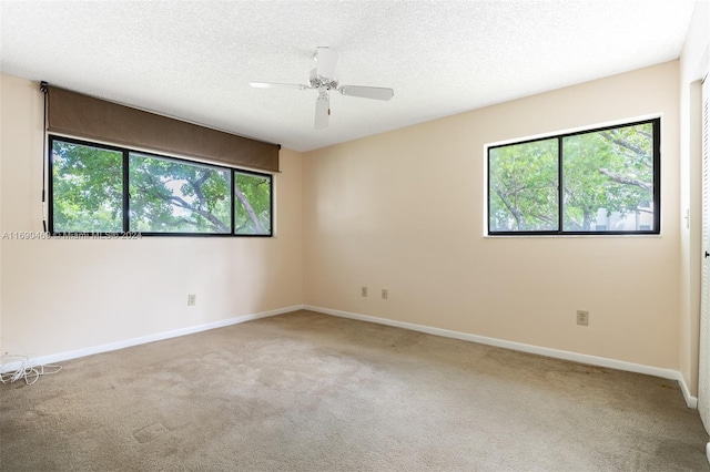 unfurnished room with ceiling fan, a healthy amount of sunlight, and carpet flooring