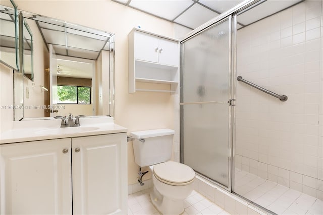 bathroom with vanity, tile patterned floors, an enclosed shower, and toilet