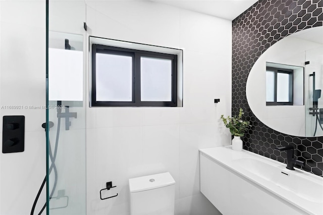 bathroom with toilet, a shower with door, tile walls, tasteful backsplash, and vanity