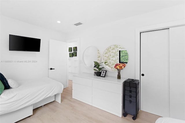 bedroom featuring light hardwood / wood-style floors and a closet