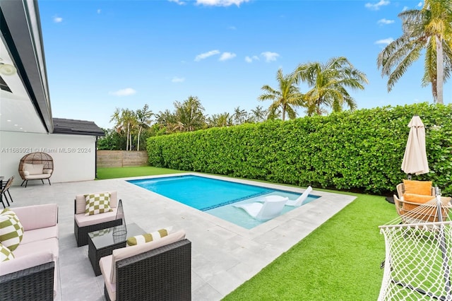 view of pool with a yard and a patio