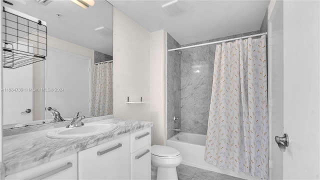 full bathroom featuring tile patterned floors, vanity, toilet, and shower / tub combo with curtain