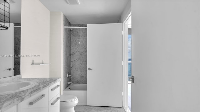 full bathroom featuring tiled shower / bath combo, toilet, and vanity