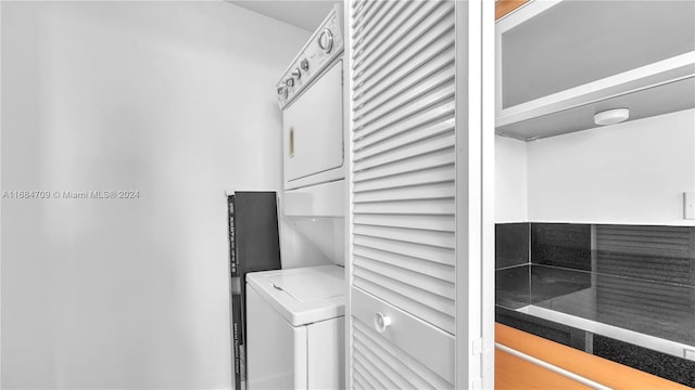 laundry room featuring stacked washer and clothes dryer