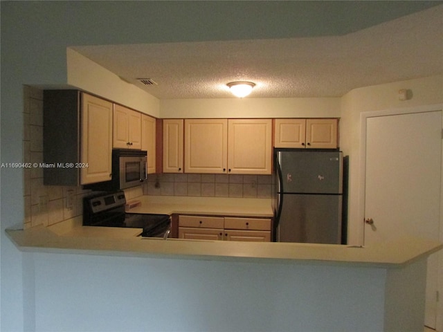 kitchen featuring appliances with stainless steel finishes and tasteful backsplash