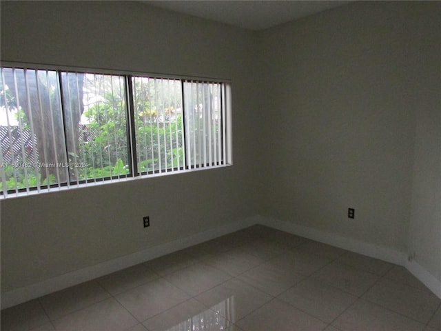 unfurnished room featuring tile patterned flooring