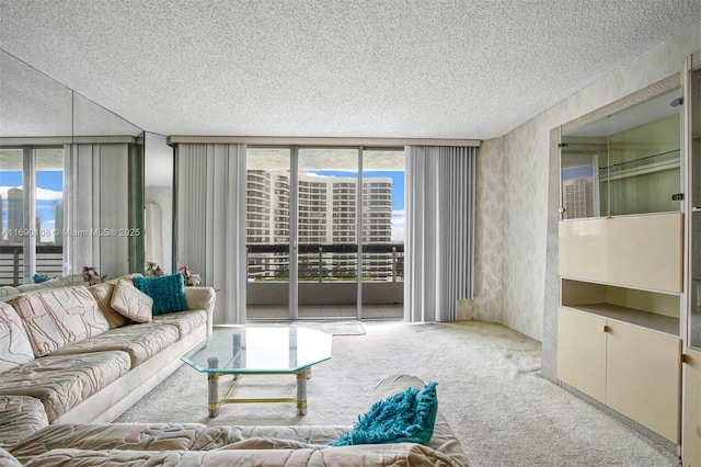 carpeted living area with a wall of windows and a textured ceiling