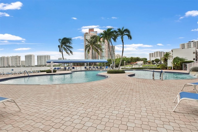 pool with a city view and a patio