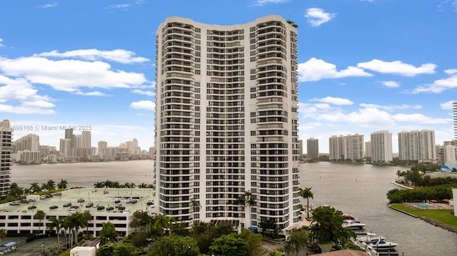 view of building exterior with a water view and a city view