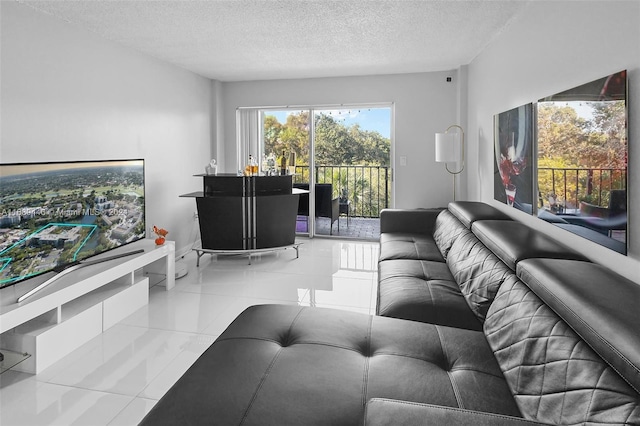 living room featuring light tile patterned floors and a textured ceiling