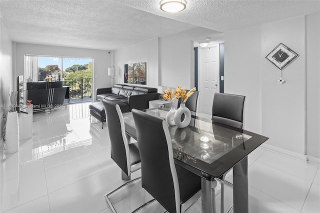 dining room featuring light tile patterned floors and a textured ceiling