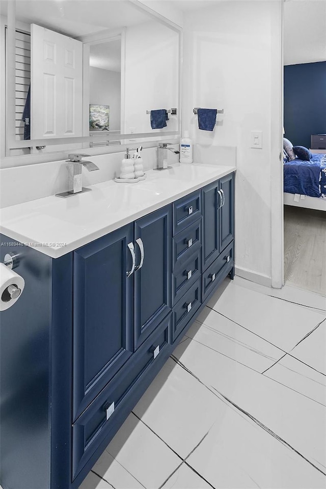 bathroom with tile patterned floors and vanity