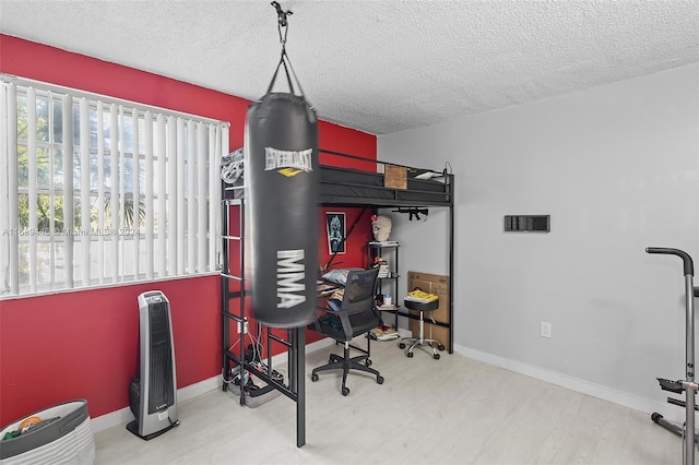 interior space with wood-type flooring and a textured ceiling