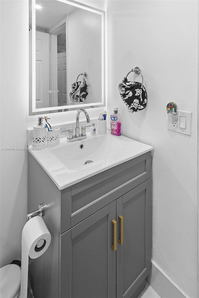 bathroom featuring vanity and toilet