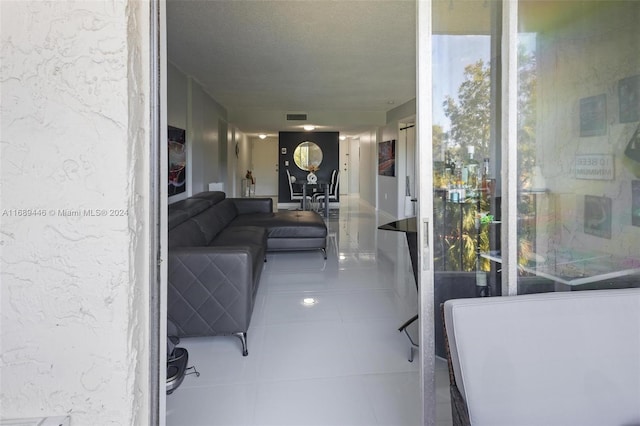 interior space with tile patterned flooring and a textured ceiling