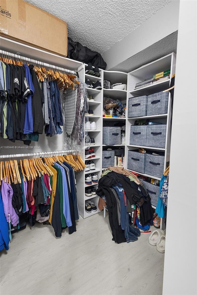 walk in closet featuring hardwood / wood-style floors