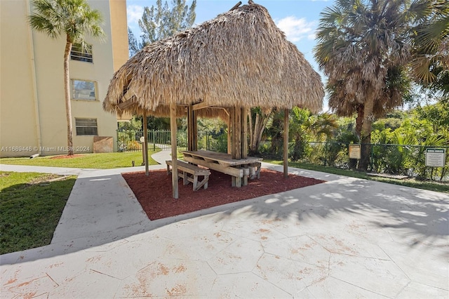 view of community with a lawn, a patio area, and a gazebo