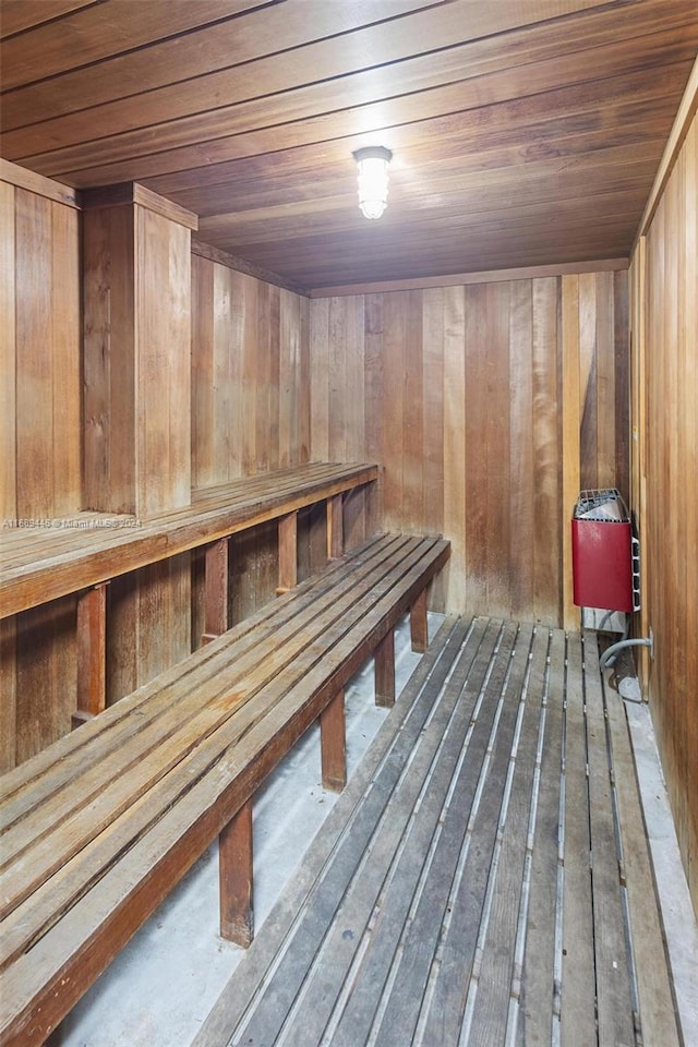 view of sauna / steam room featuring wooden walls and wood ceiling