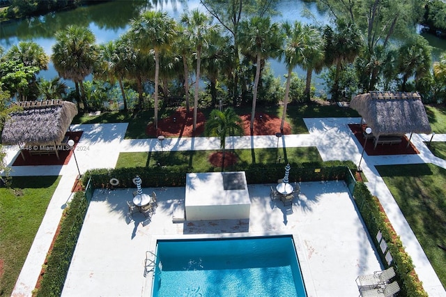 view of pool featuring a patio area and a water view