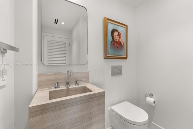 bathroom with toilet and vanity