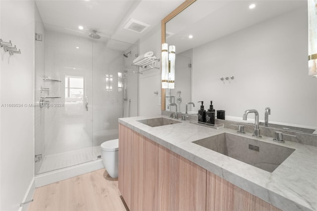 bathroom featuring walk in shower, wood-type flooring, toilet, and vanity