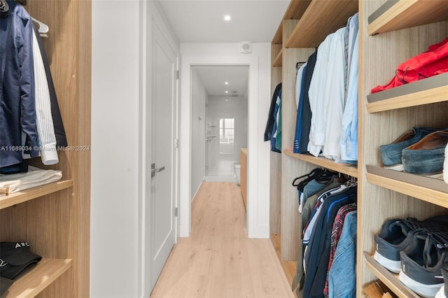 spacious closet with light hardwood / wood-style floors