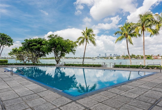 view of swimming pool featuring a water view