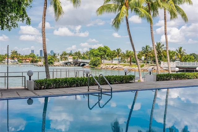 view of swimming pool featuring a water view