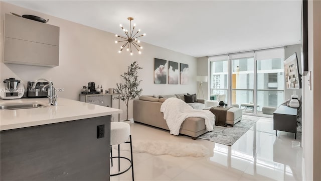 living room with a wall of windows, light tile patterned floors, sink, and a chandelier