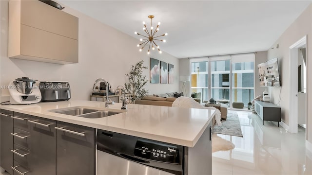 kitchen with dishwasher, floor to ceiling windows, sink, a notable chandelier, and light tile patterned flooring