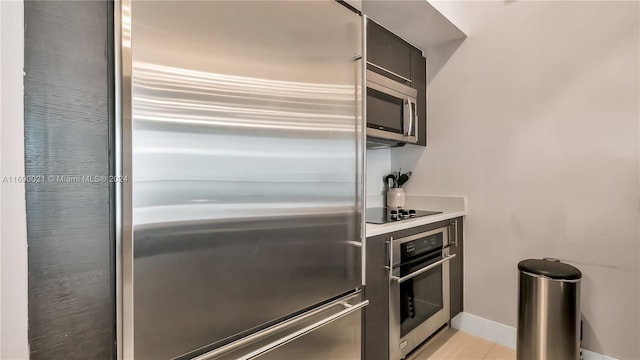 kitchen featuring light tile patterned floors and stainless steel appliances