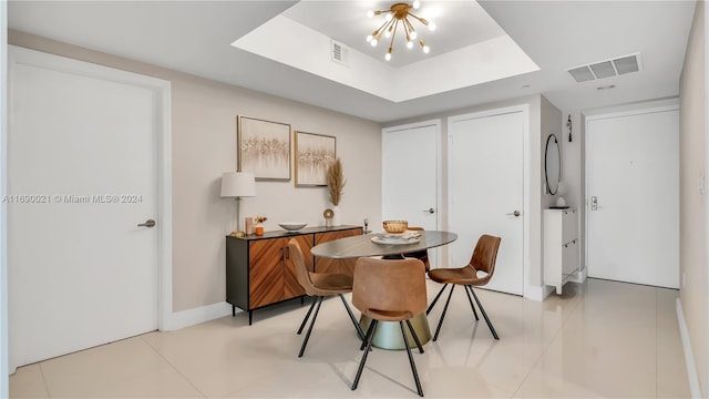 tiled dining room featuring a notable chandelier