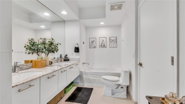 bathroom featuring tile patterned floors, vanity, a bathtub, and toilet